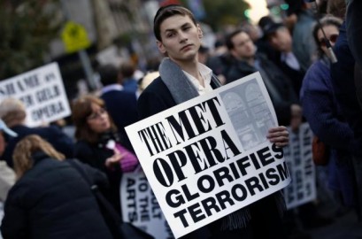 A protester holds a sign during a rally across from Lincoln Center and the New York Metropolitan Opera during a demonstration in New York, October 20, 2014. REUTERS/Mike Segar