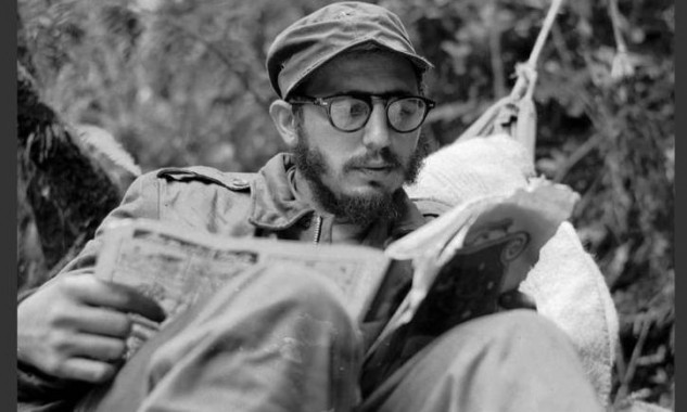 Cuban guerrilla leader Fidel Castro does some reading while at his rebel base in Cuba's Sierra Maestra mountains in this 1957 photo. (AP Photo/Andrew St. George)