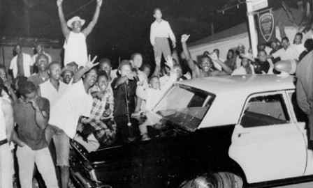 ** FILE ** Demonstrators push against a police car after rioting erupted in a crowd of 1,500 in the Los Angeles area of Watts in this file photo taken August 12, 1965. The 40th anniversary of the start of the six-day uprising is Thursday, Aug. 11. (AP Photo/File)